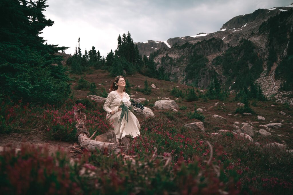 elopement-bridal-portrait-seating-in-a-meadow-at-iceberg-lake-Trail-near-Whistler