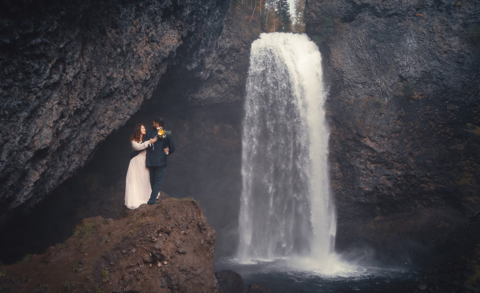 elopement portrait wedding photoshott outdoor couple standing near a waterfall in Wells Grey Provincial Park