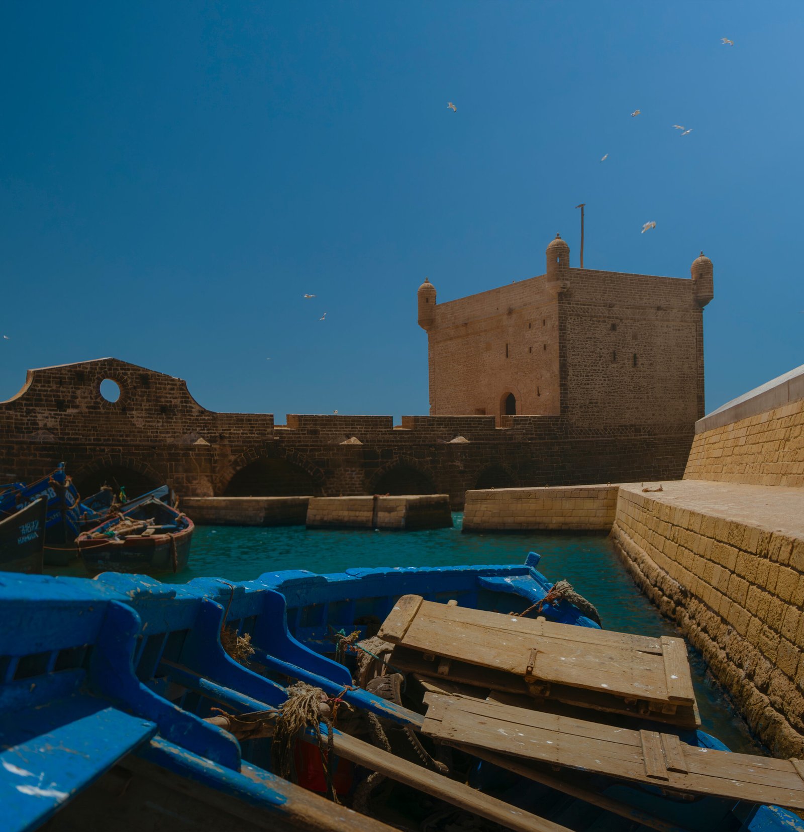 elopement and honeymoon destination worldwide photography service outdoor wedding by the ocean with castle and tower
