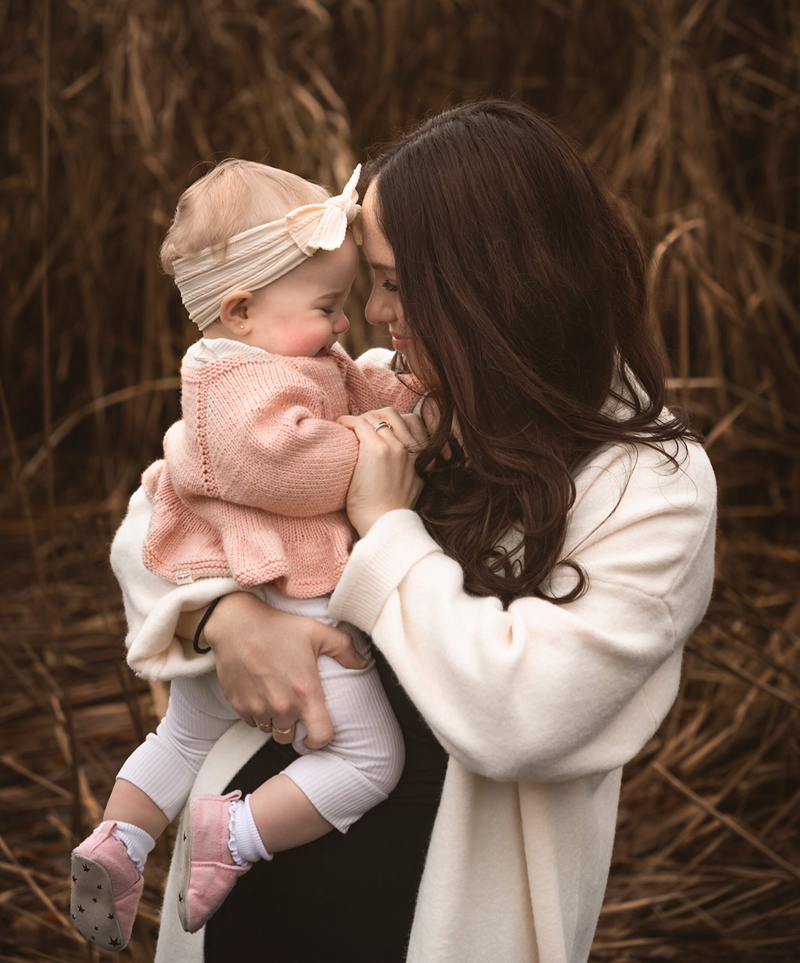 family portrait session in nature in autumn mother holdinh her baby with love professional photoshoot in vancouver